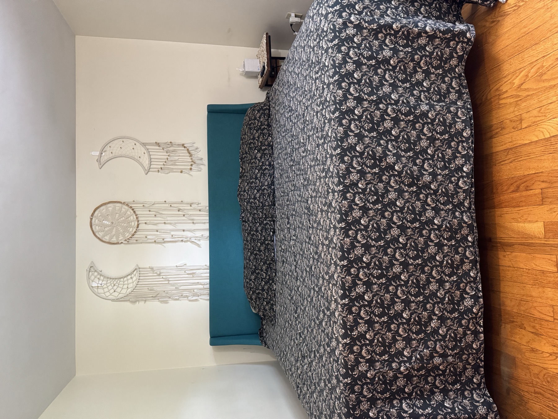 Buell St Airbnb bedroom with bed, side table, and bright natural light.