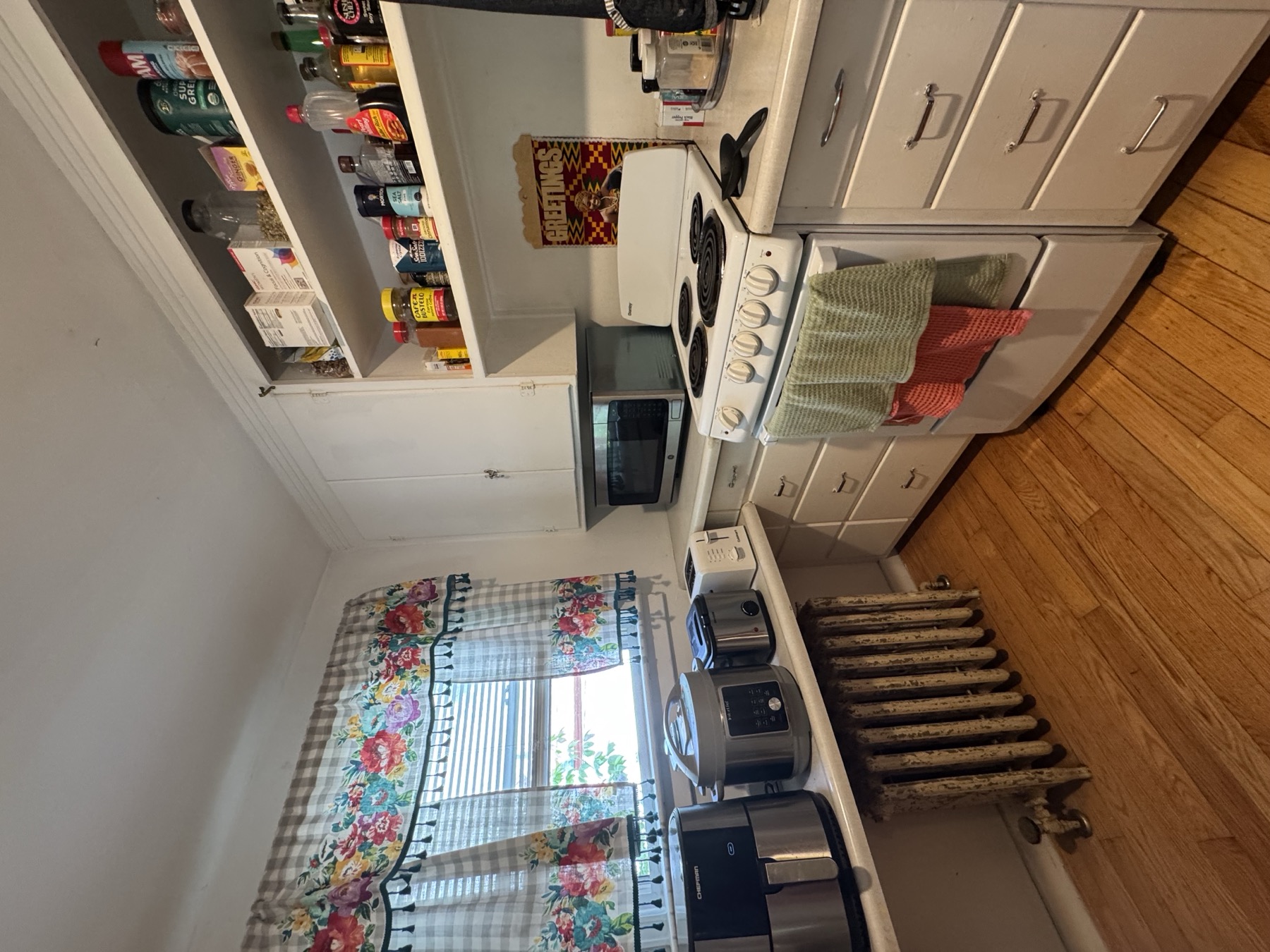 Buell St Airbnb kitchen with counters, appliances, and work area.