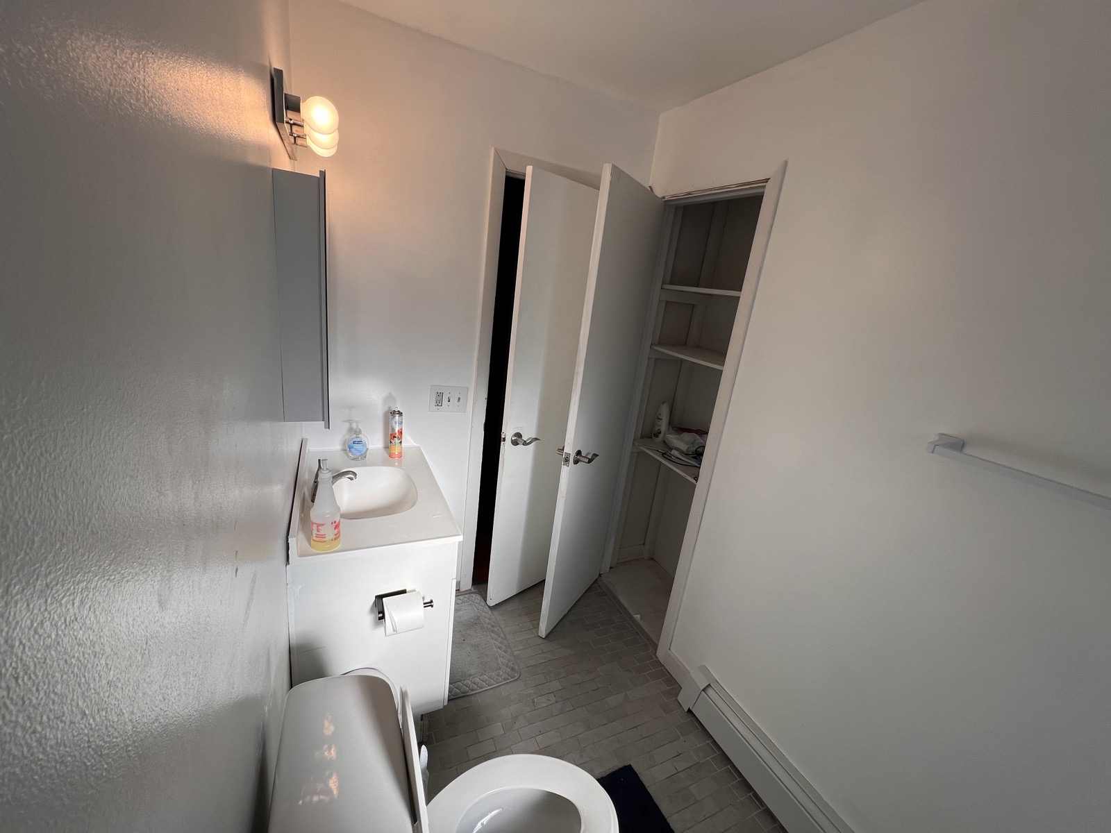 Rosewood Rental bathroom with vanity, mirror, and storage closet.