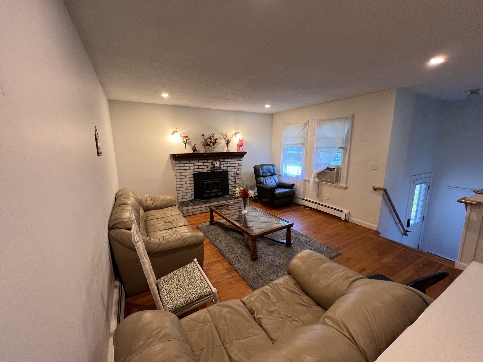 Rosewood Rental living room with seating, fireplace, and common area layout.